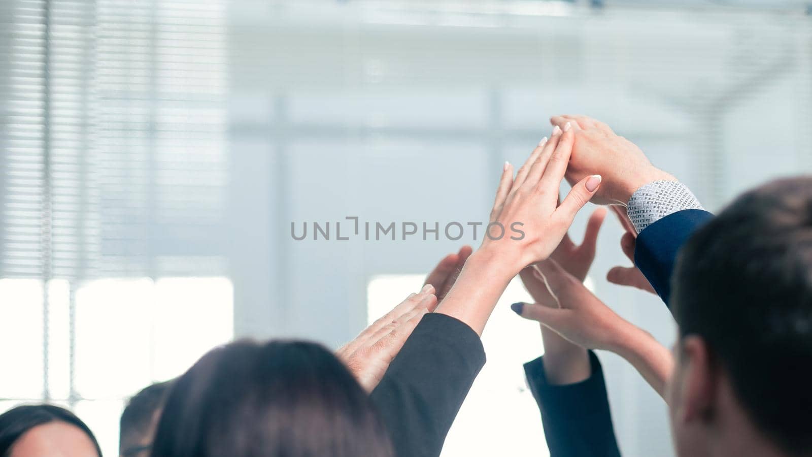 close up. a group of employees joining their palms by SmartPhotoLab