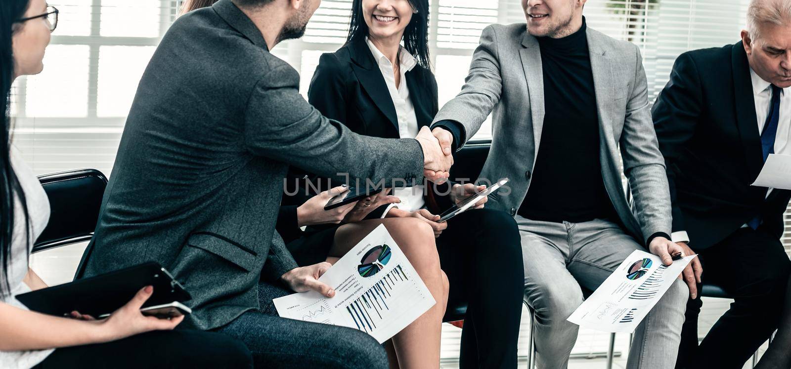 business colleagues shaking hands at an office meeting. concept of cooperation