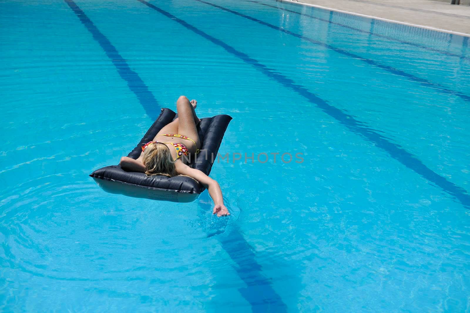 beautiful woman relax on swimming pool by dotshock