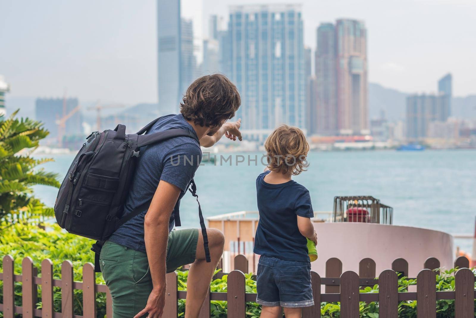 Father and son are walking around Hong Kong. Traveling with children concept by galitskaya