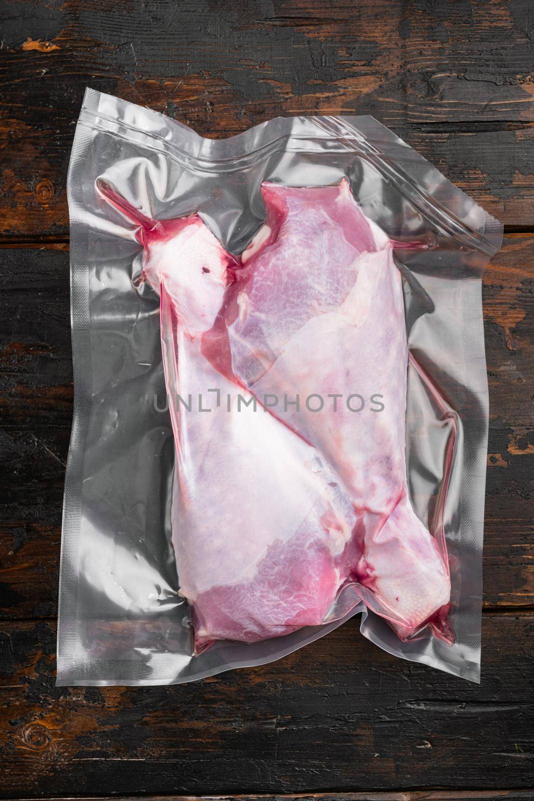 Poultry vacuum packed pack set, top view flat lay, on old dark wooden table background