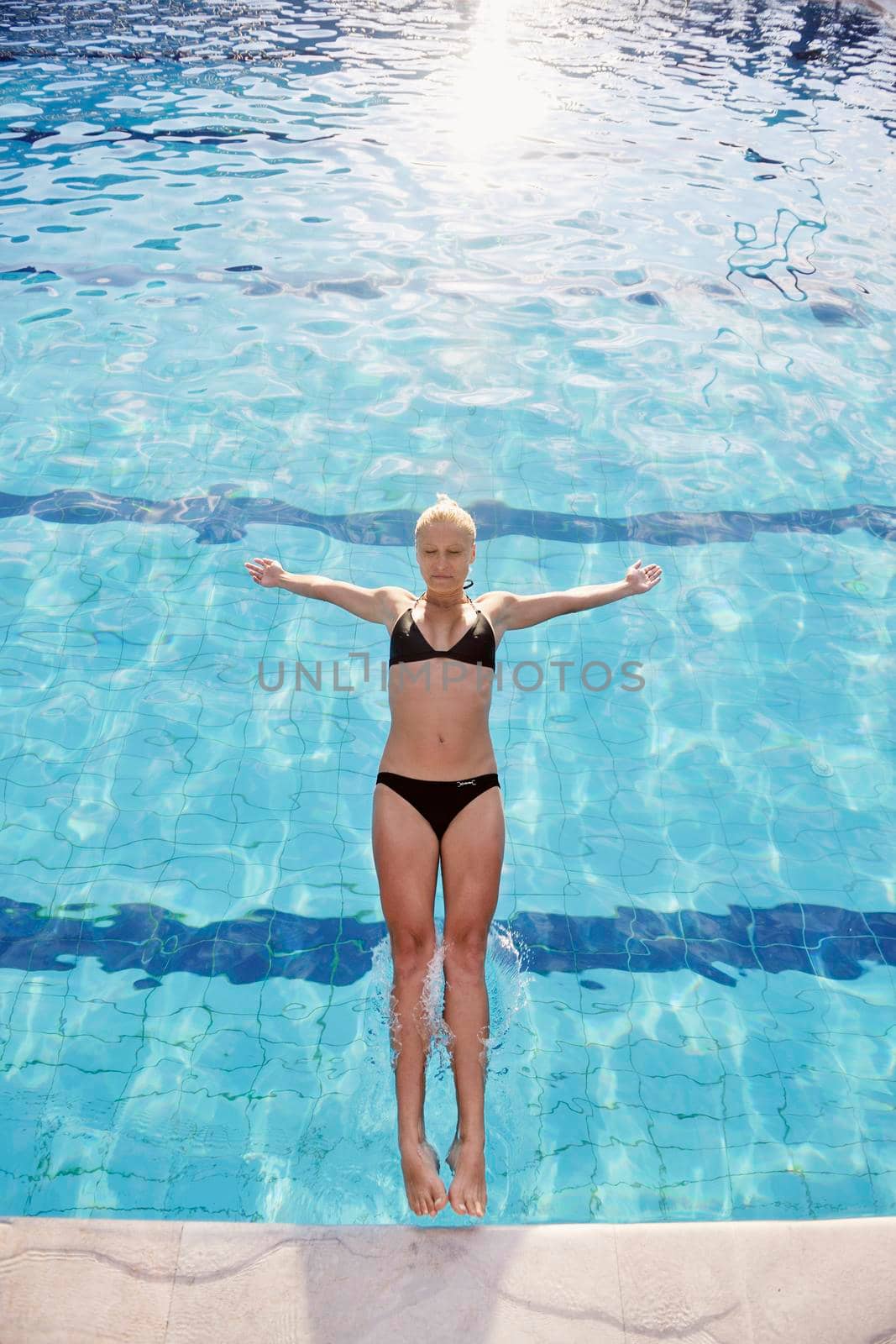 young beautiful woman relax and have fun with splashing water at hotel swimming pool young beautiful woman relax and have fun with splashing water at hotel swimming pool