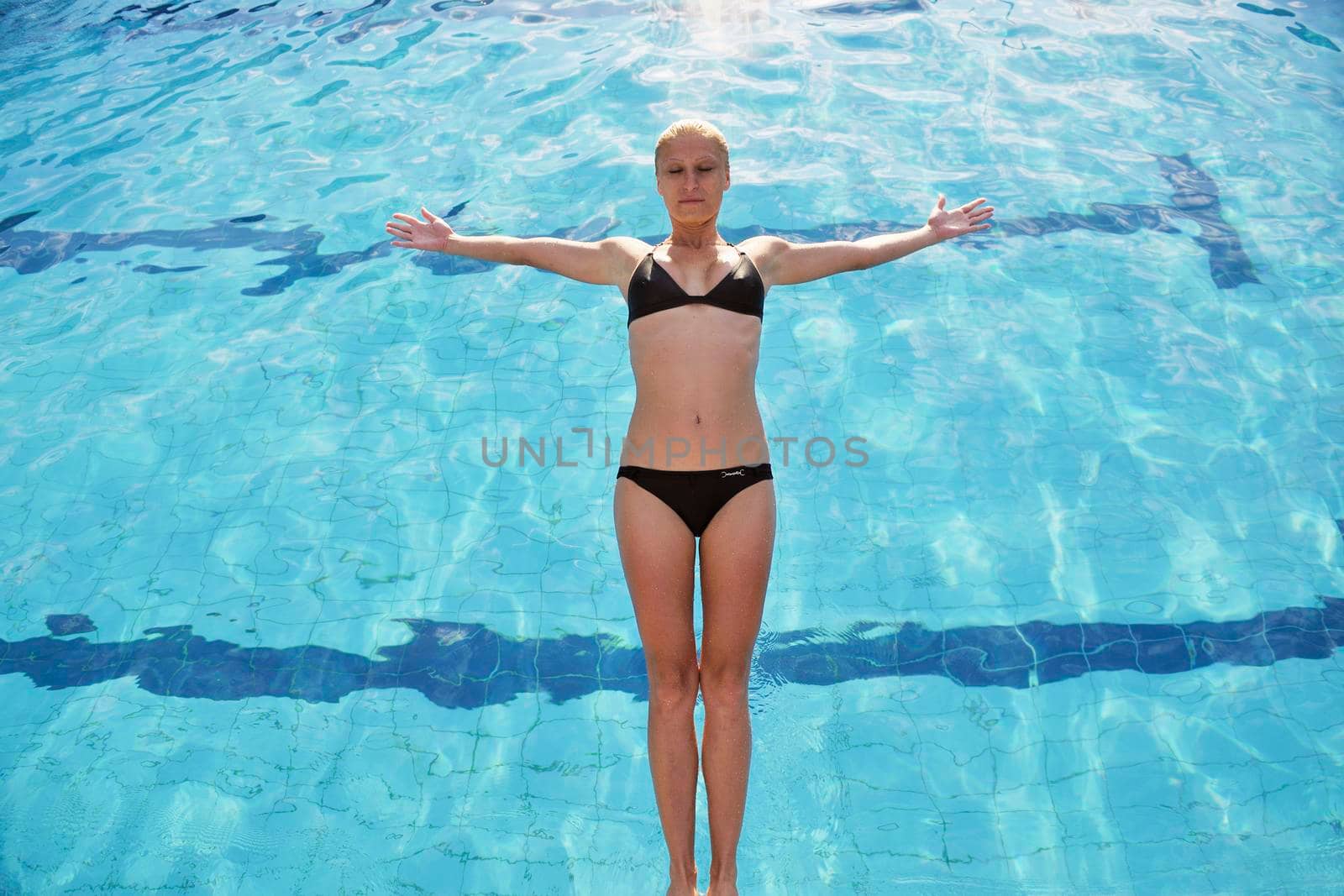 young beautiful woman relax and have fun with splashing water at hotel swimming pool young beautiful woman relax and have fun with splashing water at hotel swimming pool