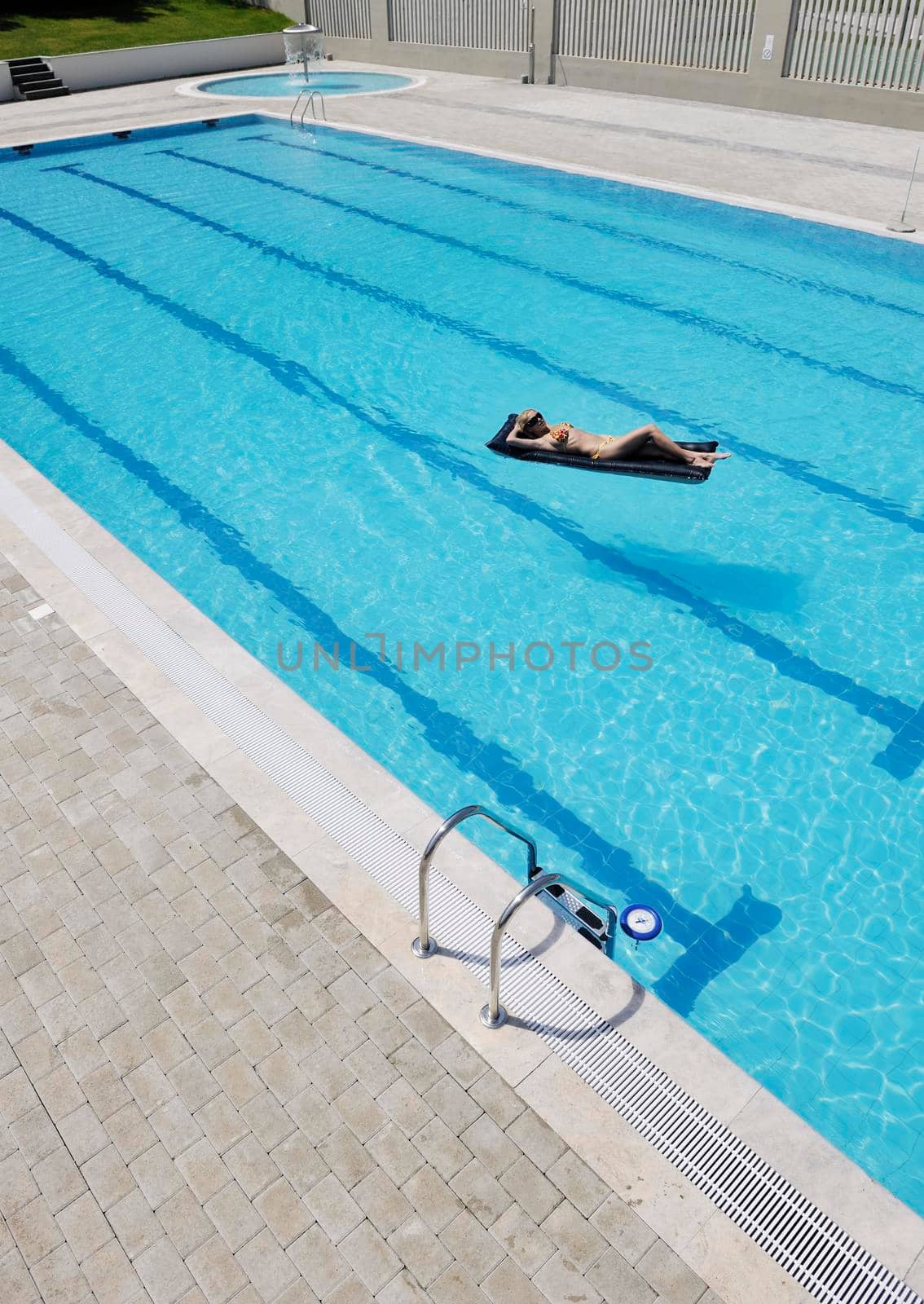 beautiful young woman relax and have fun at swimming pool