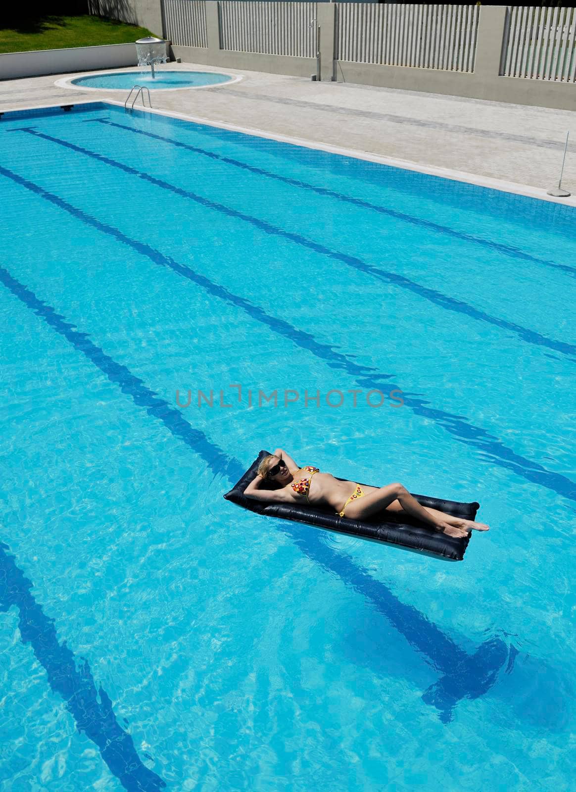 beautiful woman relax on swimming pool by dotshock