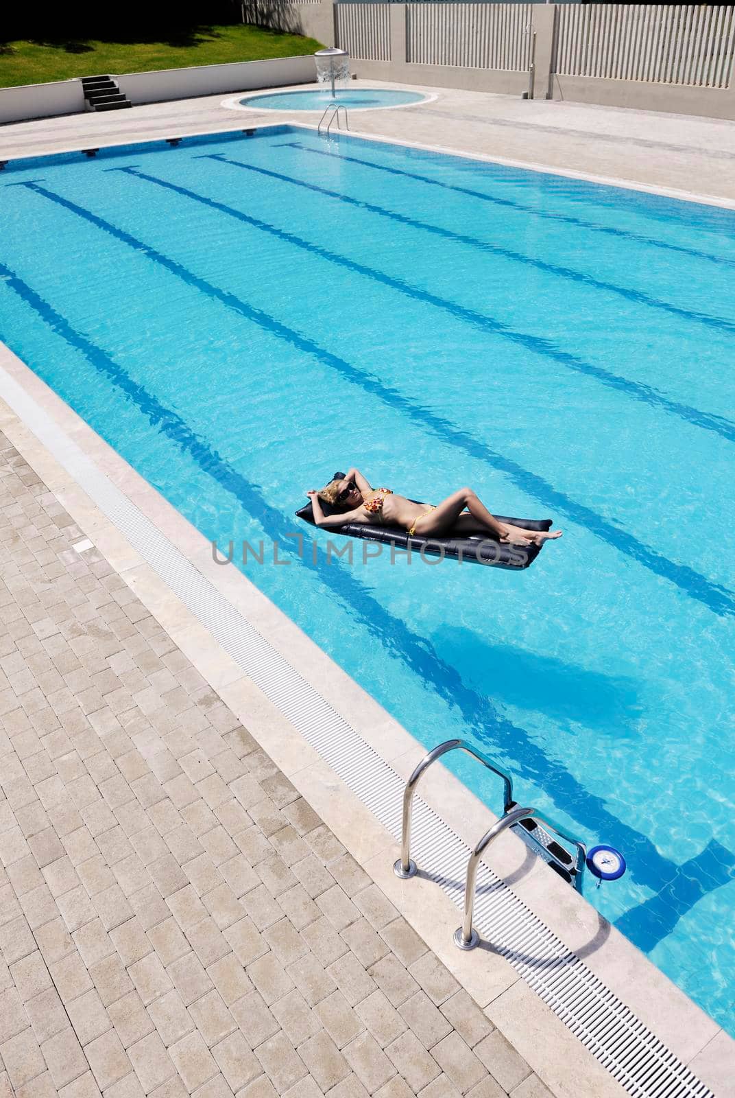beautiful woman relax on swimming pool by dotshock