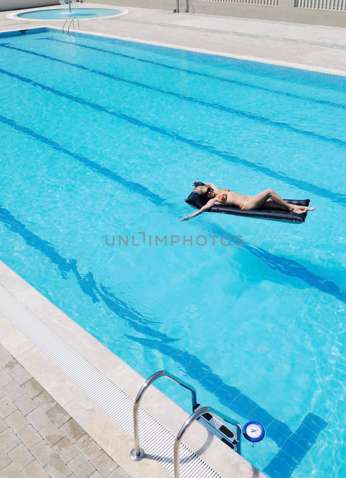 beautiful young woman relax and have fun at swimming pool