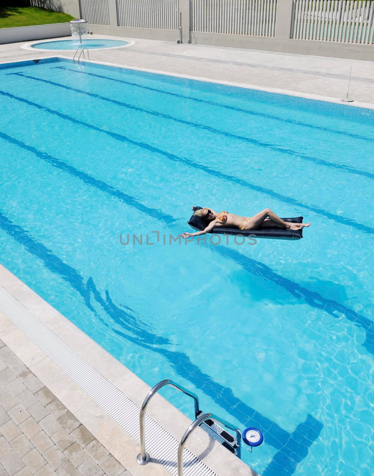 beautiful woman relax on swimming pool by dotshock