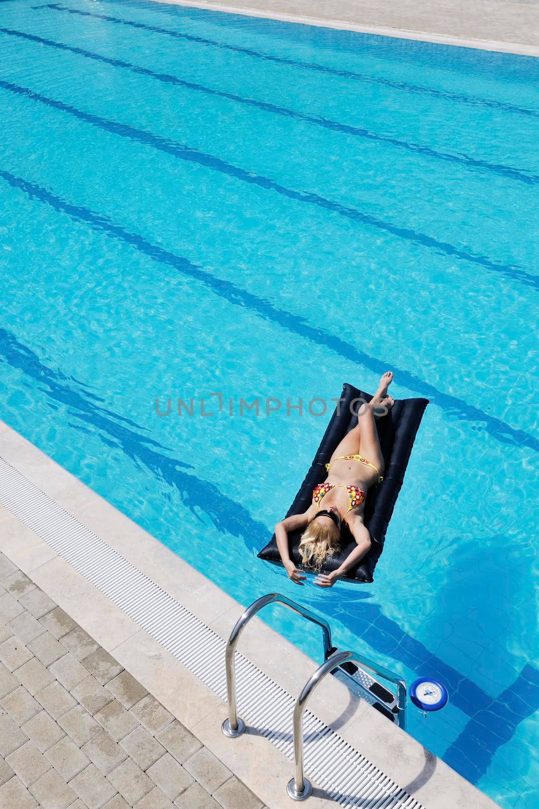 beautiful woman relax on swimming pool by dotshock