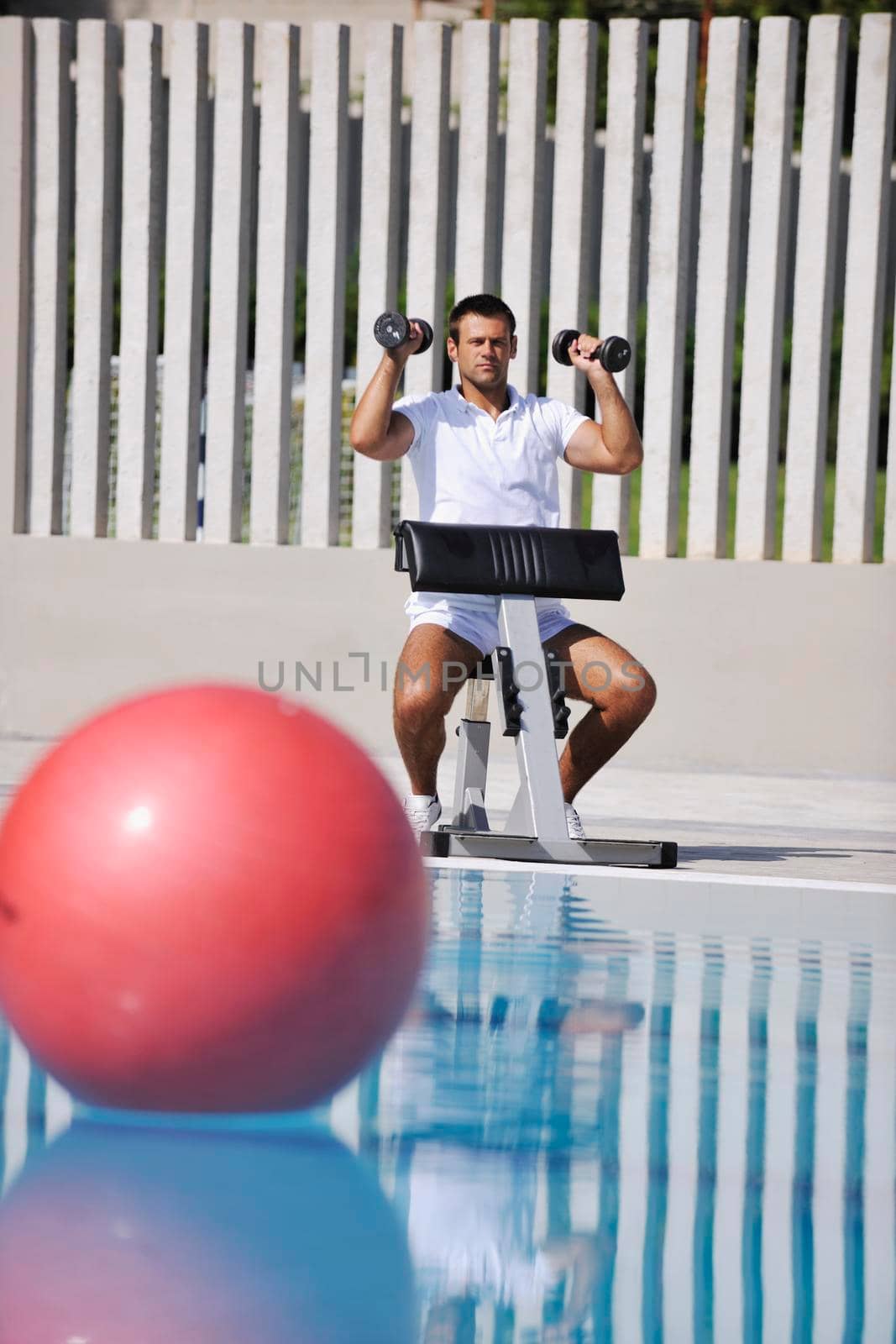 young healthy athlete man exercise at poolside