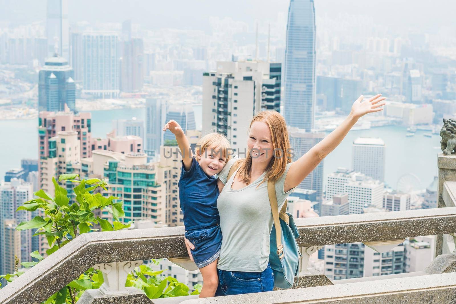 Mom and son travelers at the peak of Victoria against the backdrop of Hong Kong. Traveling with children concept by galitskaya