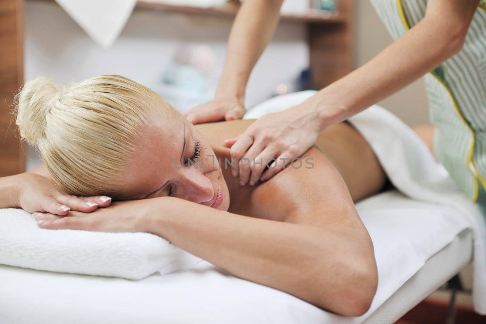 woman back massage treatment by dotshock