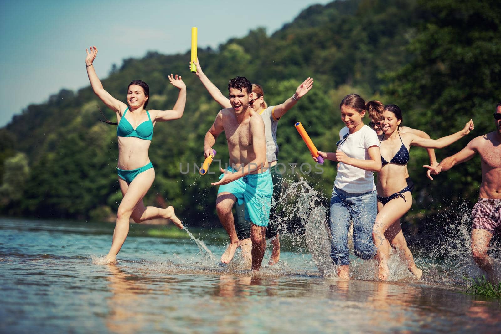 summer joy friends having fun on river by dotshock