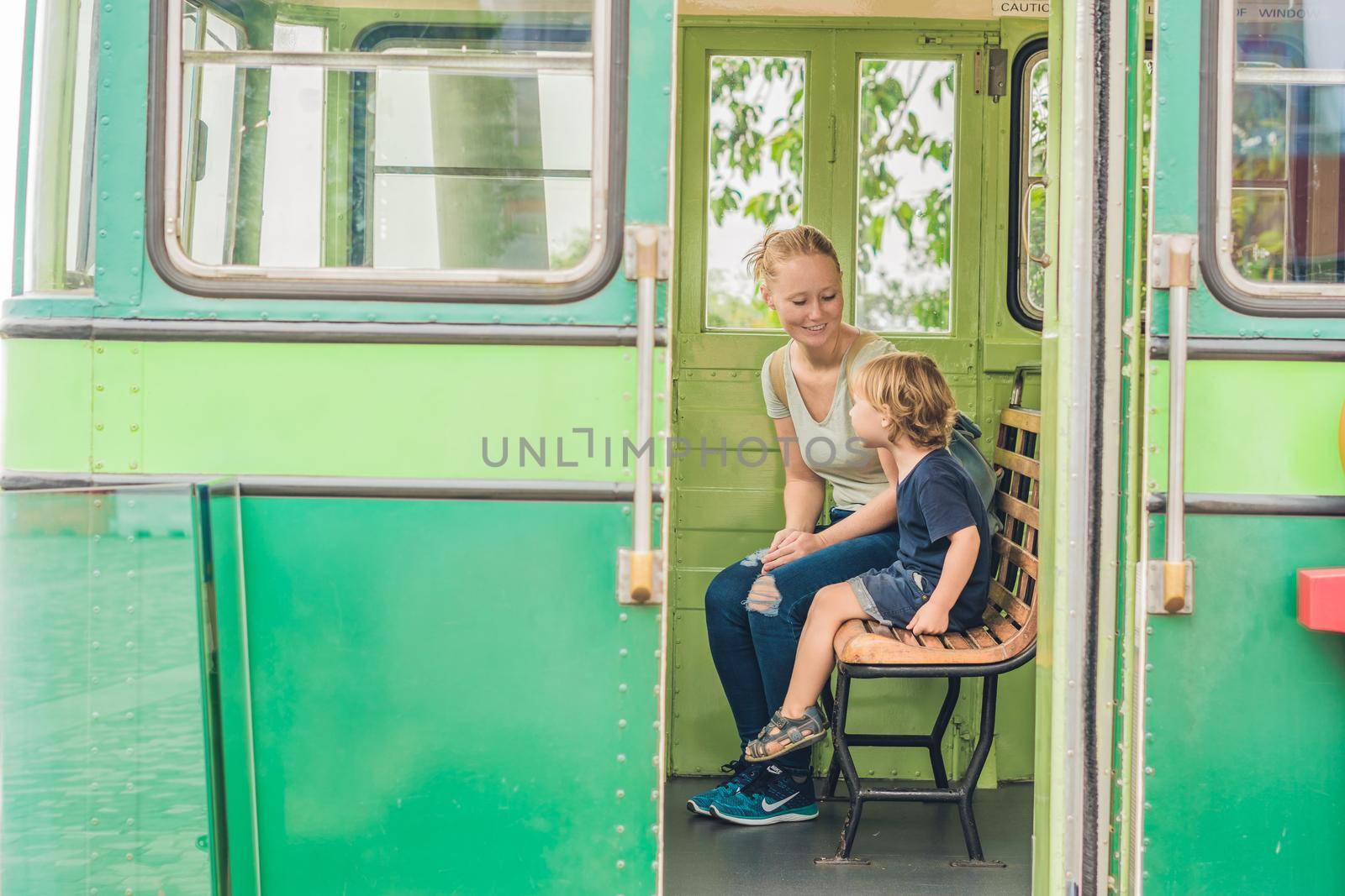 Mom and son are going to go on an old tram. Traveling with children in Hong Kong concept.