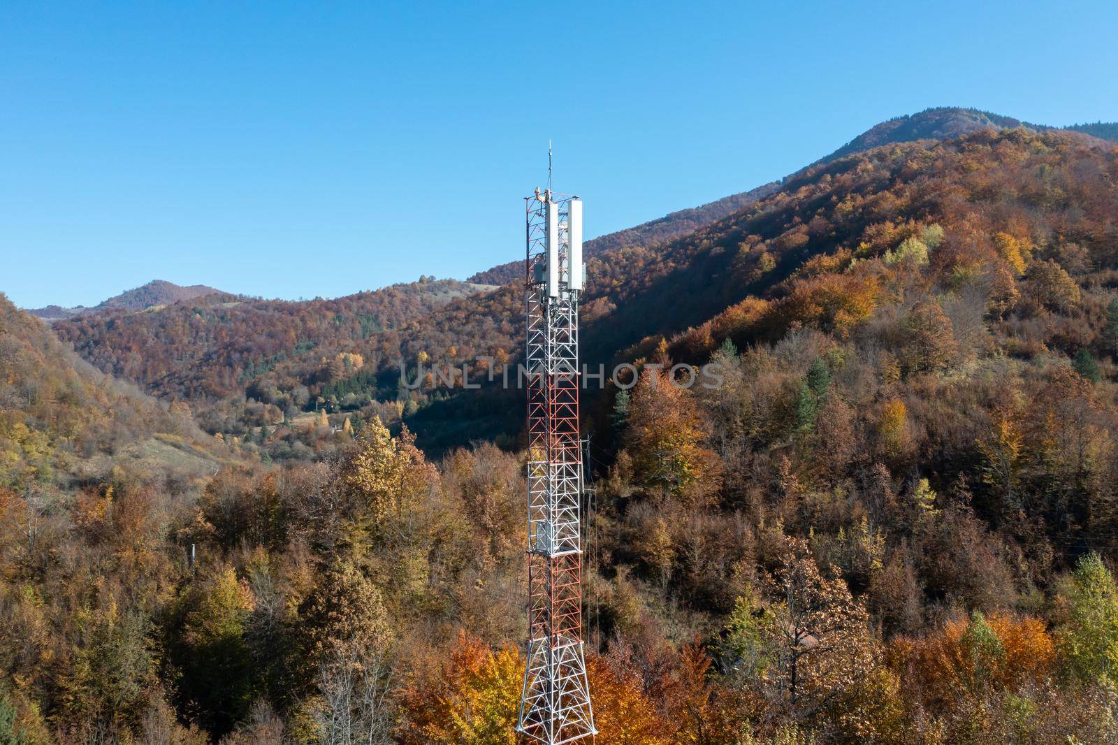 Telecommunications antenna tower in the morning. bright sunshine and blue sky with clouds. Transmitting antenna pairs. High quality photo