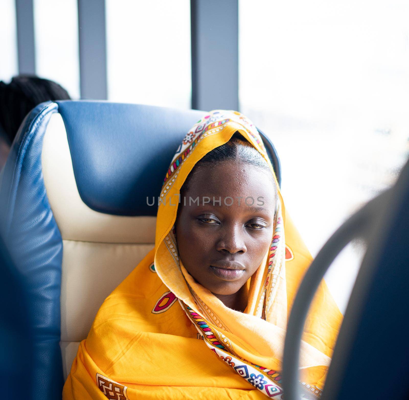 Beautiful black young woman traveling alone near window