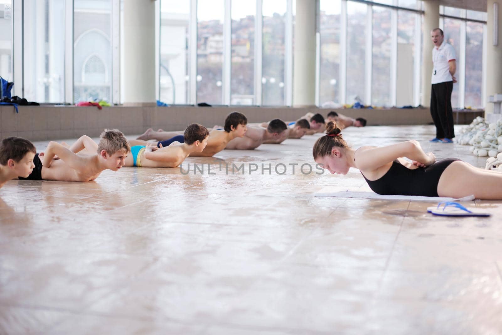 happy children kids group  at swimming pool class  learning to swim