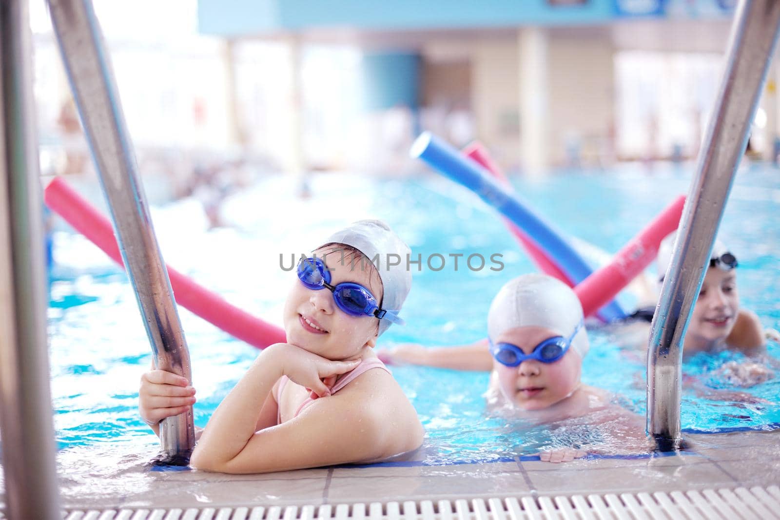happy children group  at swimming pool by dotshock