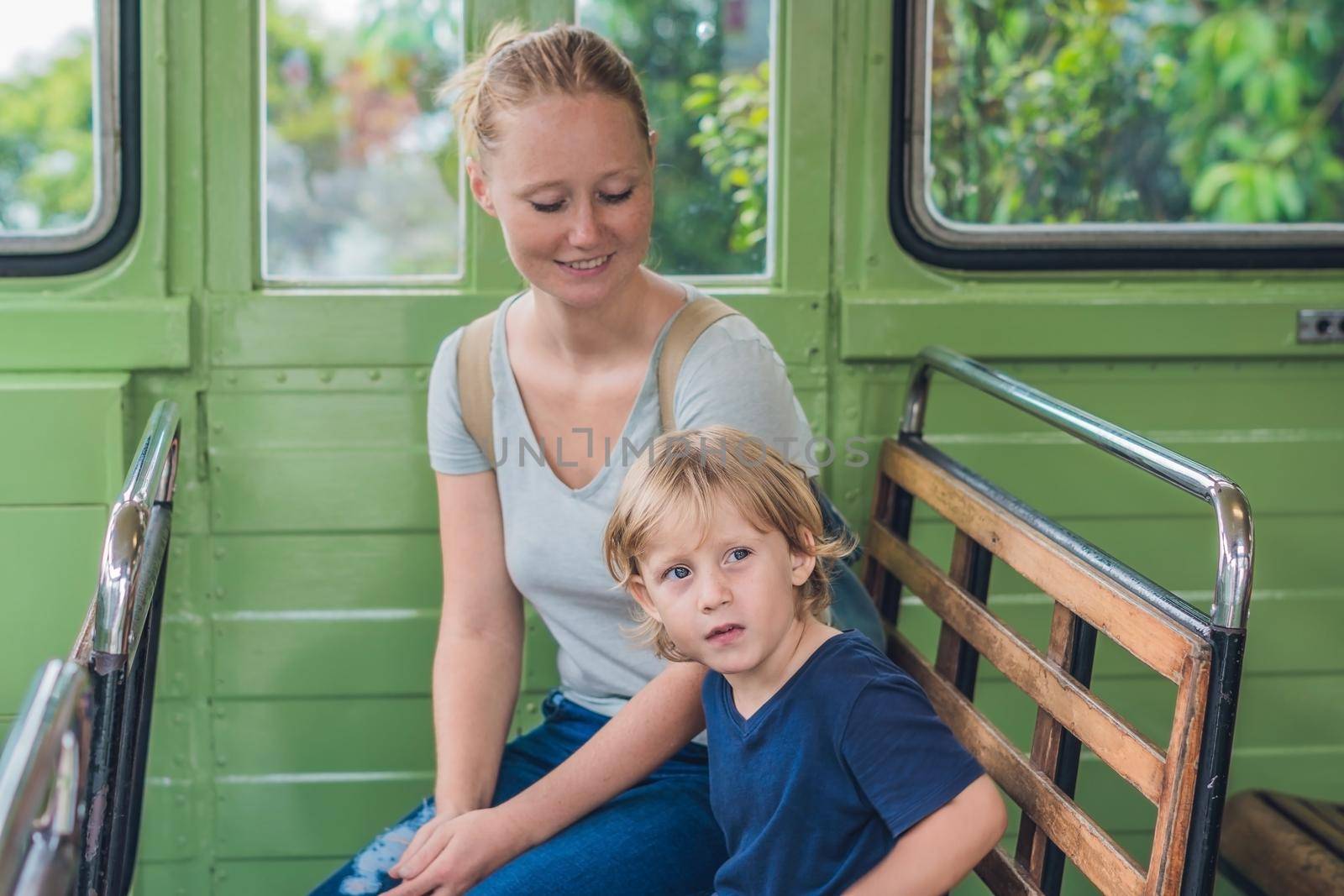Mom and son are going to go on an old tram. Traveling with children in Hong Kong concept by galitskaya