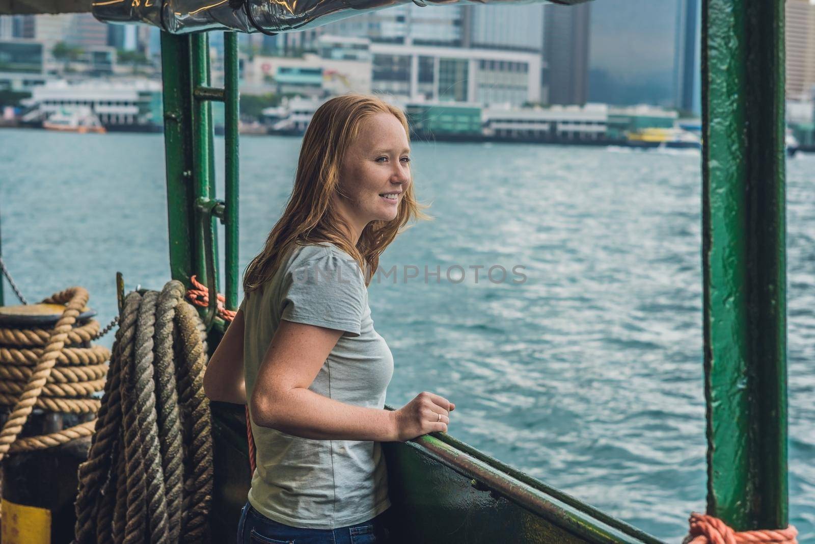Young woman on a ferry in Hong Kong by galitskaya