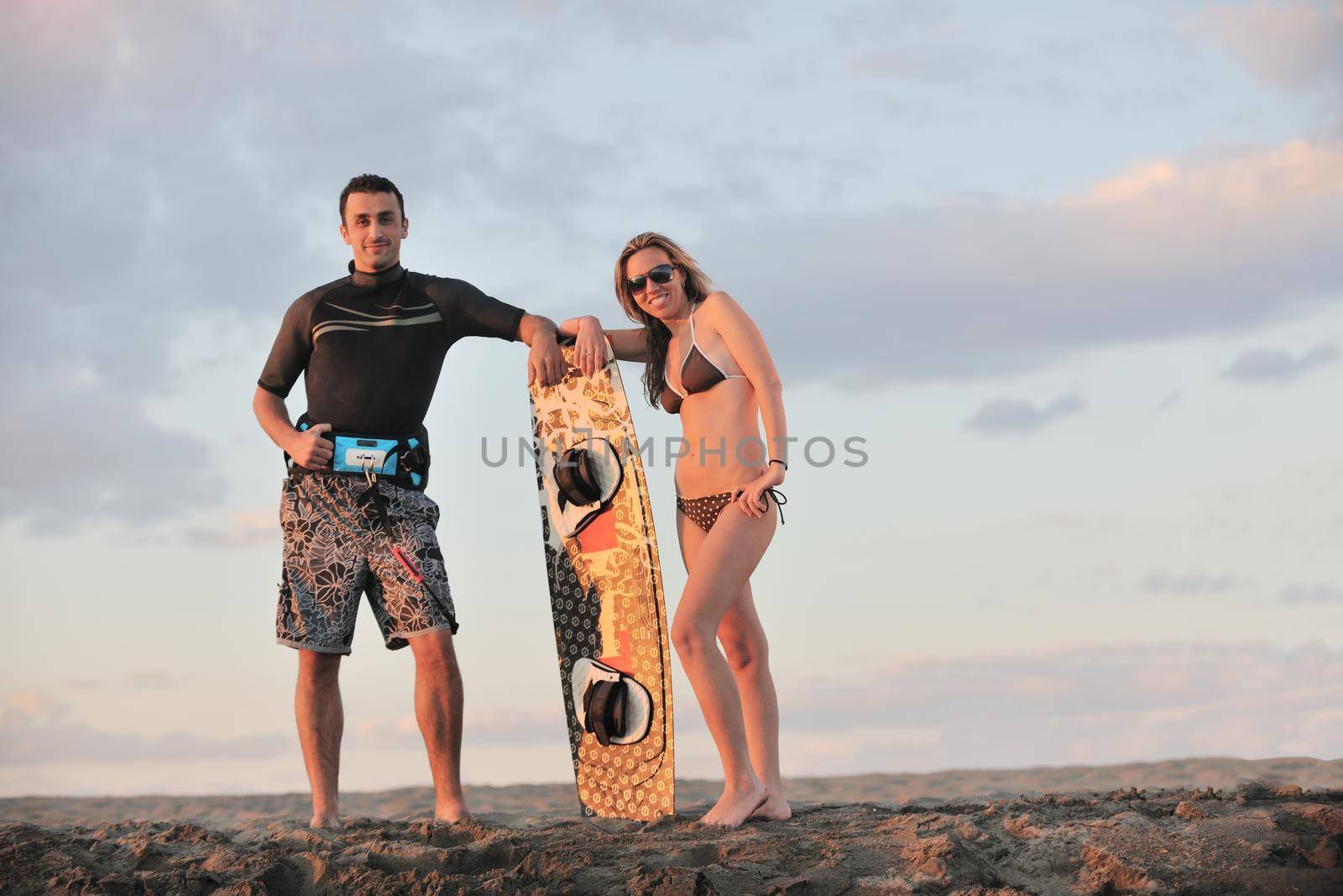 surf couple posing at beach on sunset by dotshock
