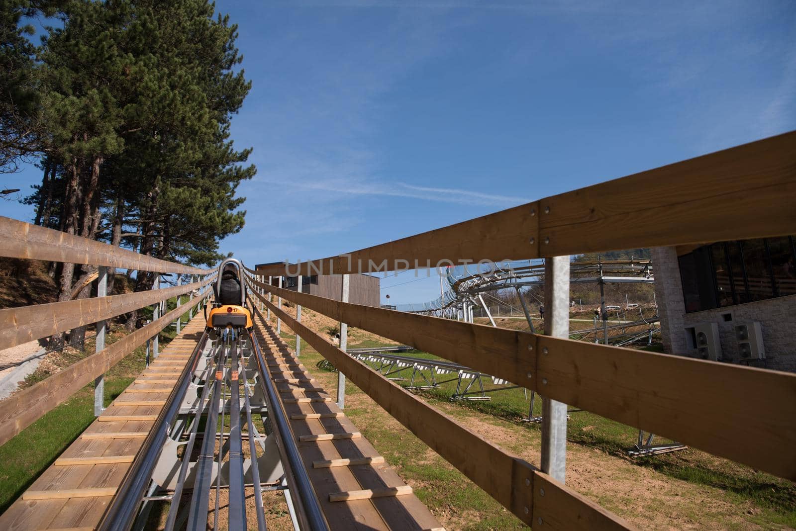 mother and son enjoys driving on alpine coaster by dotshock
