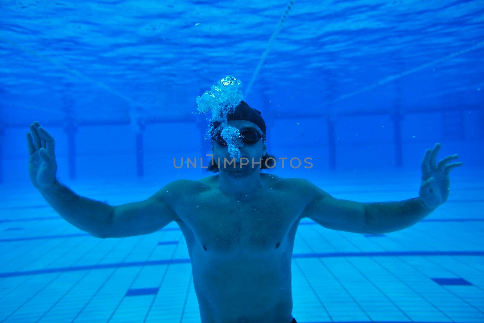 undervater shoot of swimming pool with good looking young swimmer 