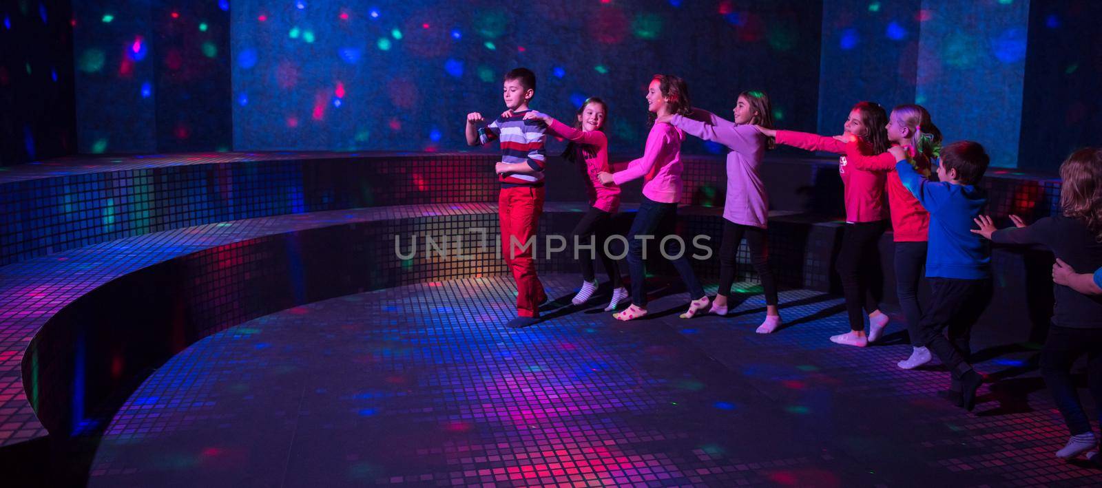 A group of joyful children happily spending time at Kids neon disco party