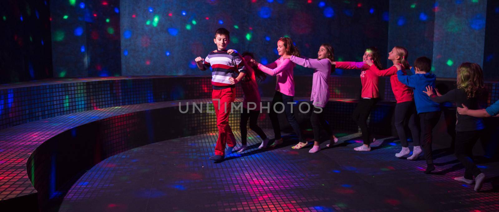 A group of joyful children happily spending time at Kids neon disco party