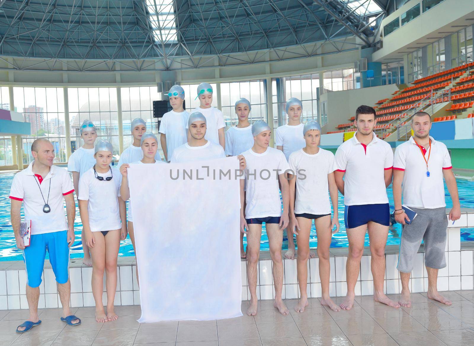 portrait group of happy kids children  at swimming pool school with empty white flag