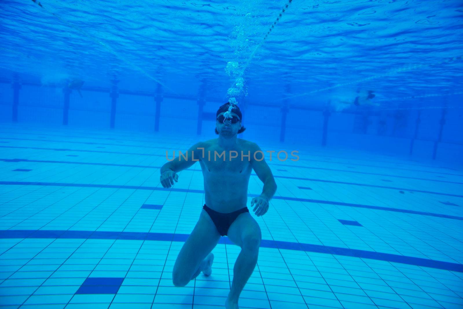 undervater shoot of swimming pool with good looking young swimmer 