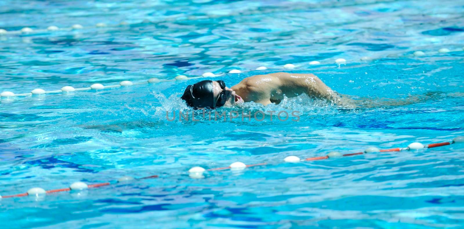 young healthy with muscular body man swim on swimming pool and representing healthy and recreation concept