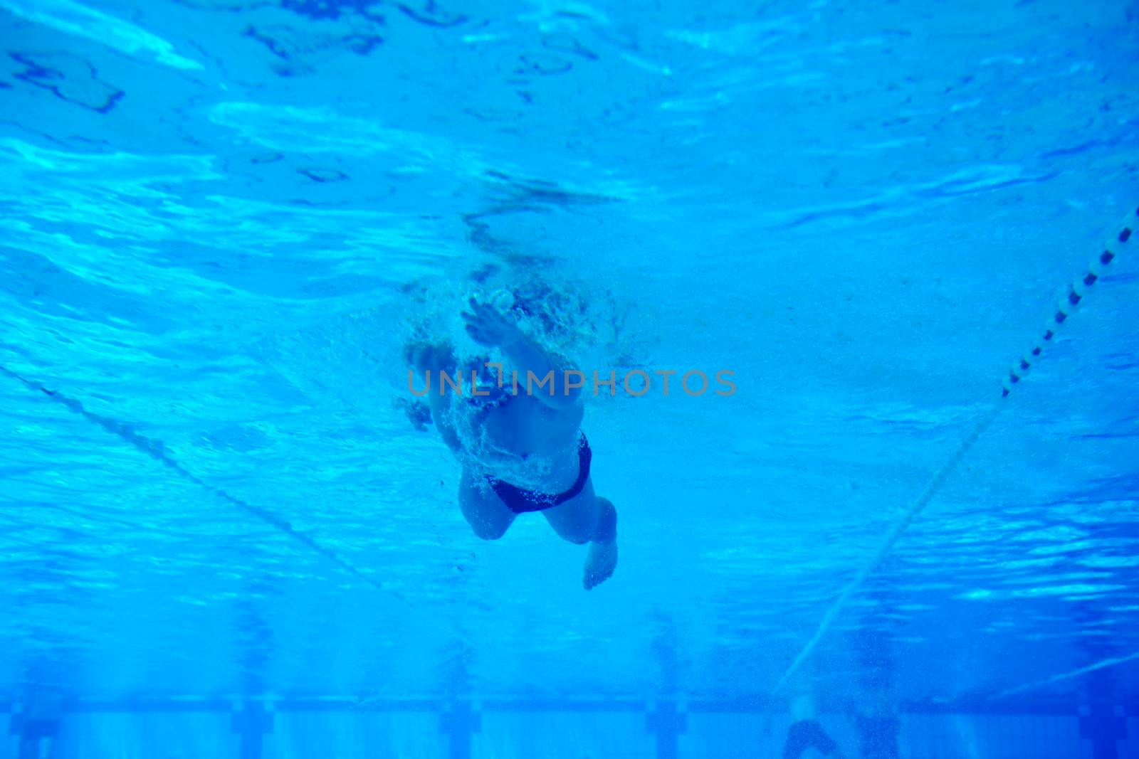 undervater shoot of swimming pool with good looking young swimmer 