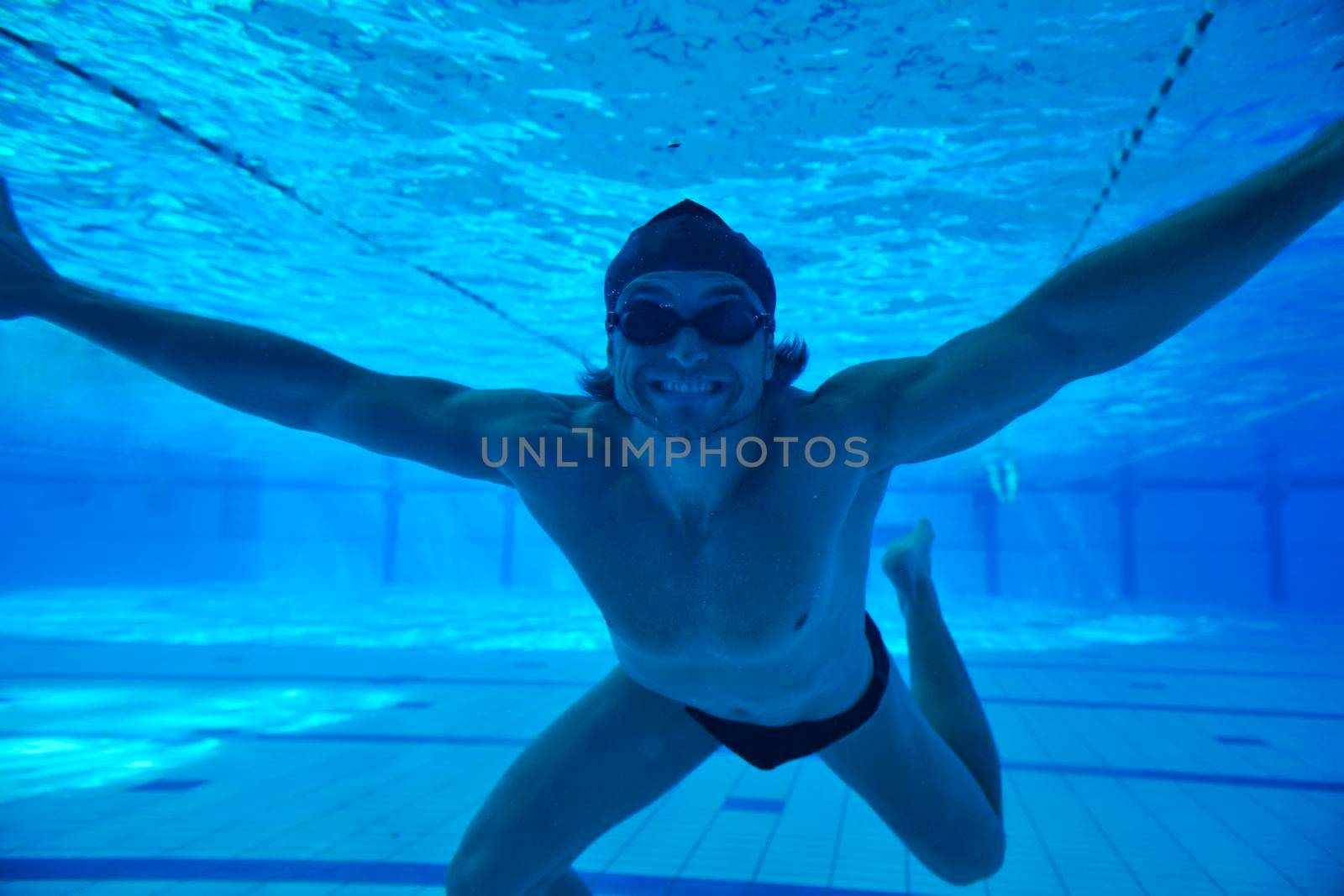 undervater shoot of swimming pool with good looking young swimmer 