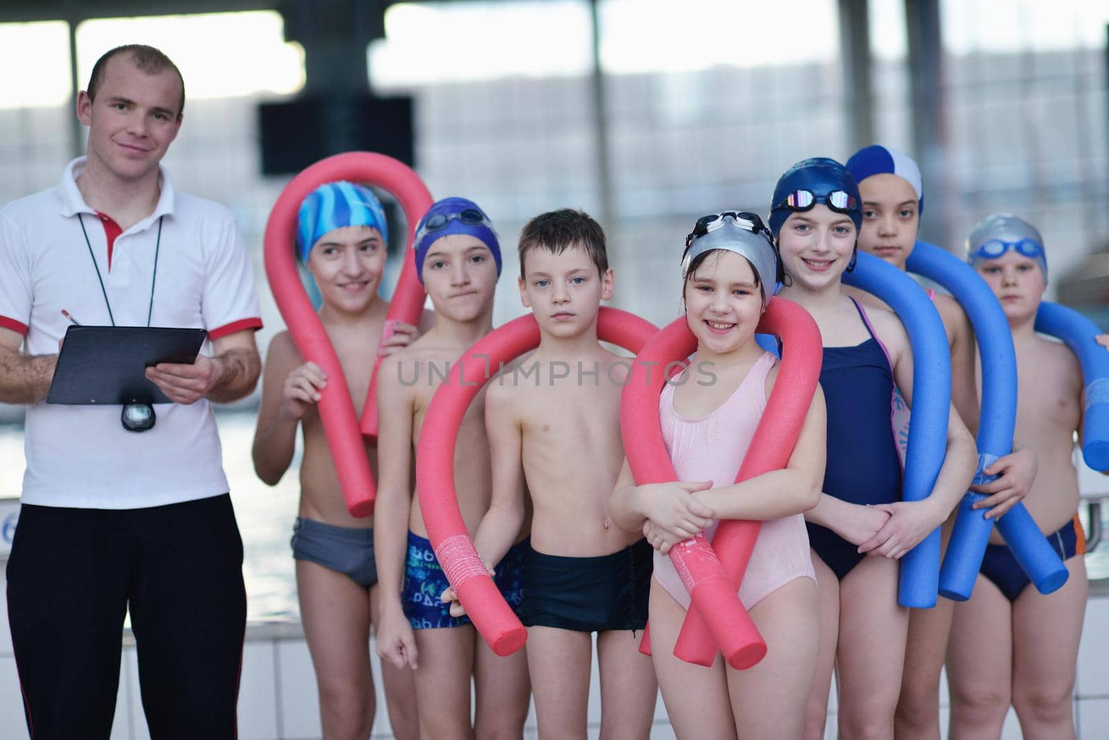 happy children group  at swimming pool by dotshock