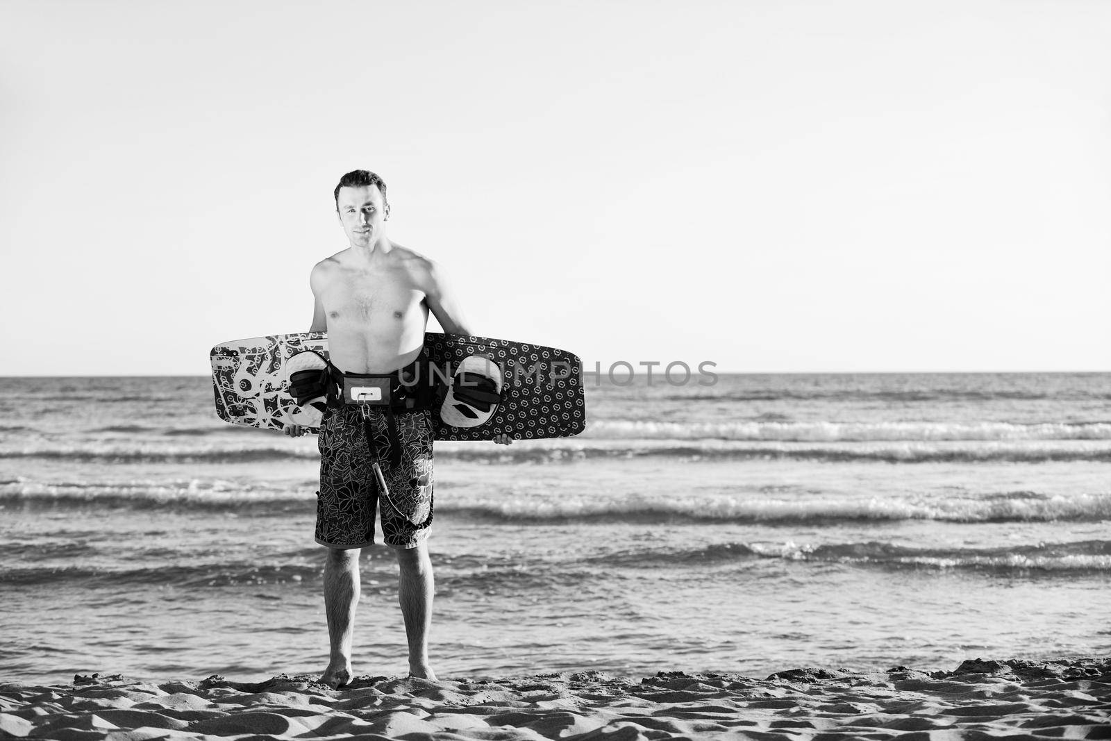 Portrait of a young  kitsurf  man at beach on sunset by dotshock