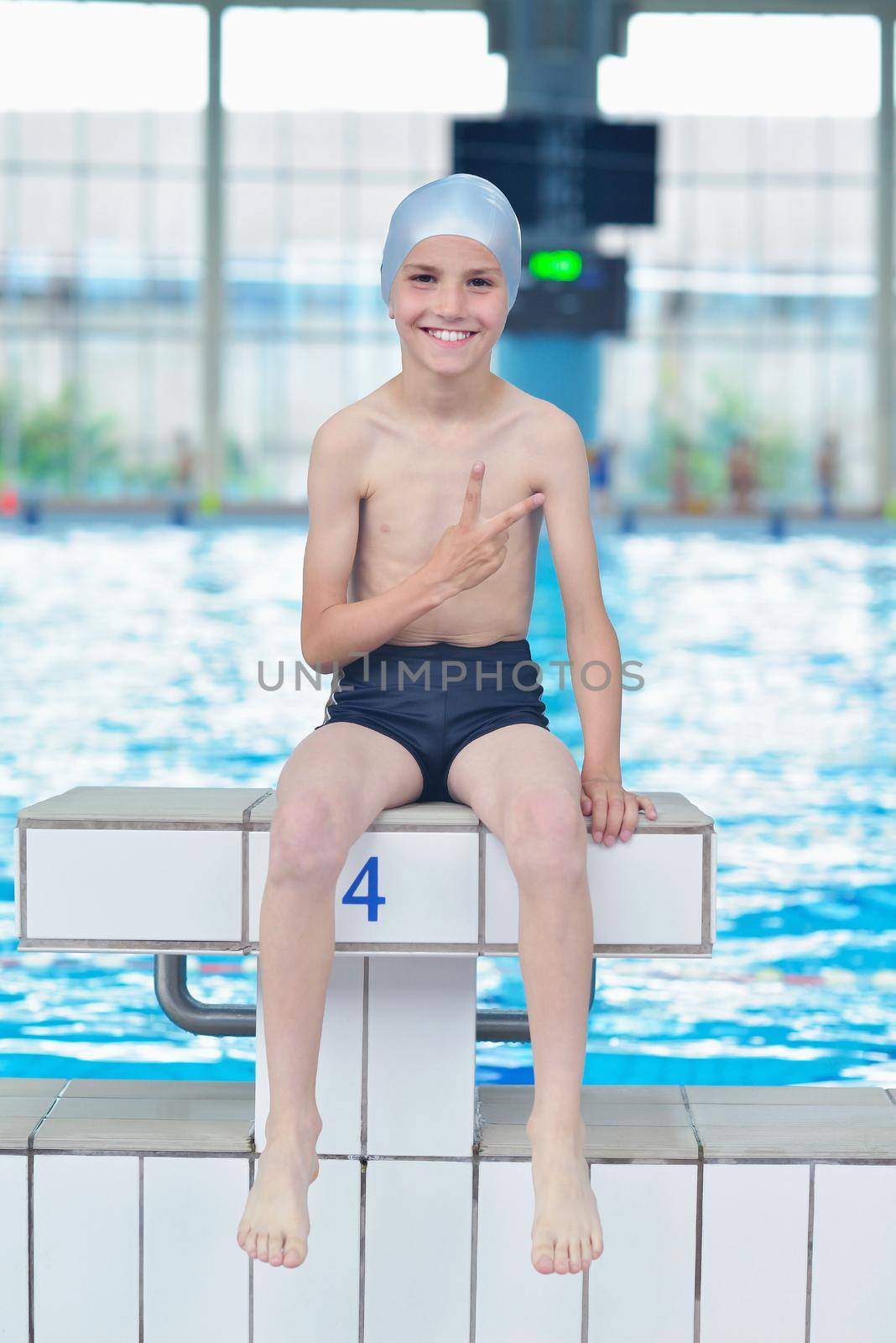 happy little child portrait on swimming school classes and recreation at indoor pool