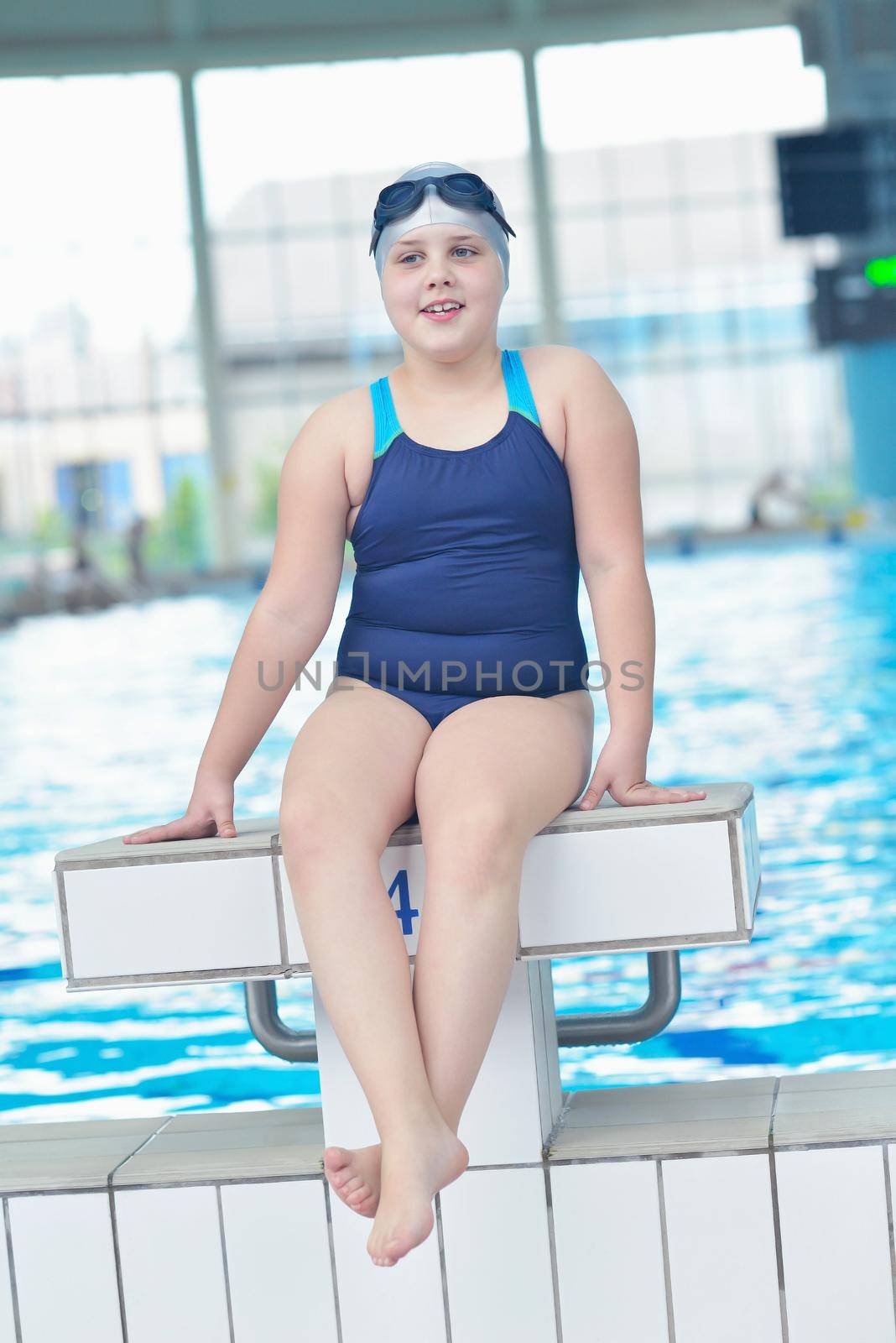 happy little child portrait on swimming school classes and recreation at indoor pool