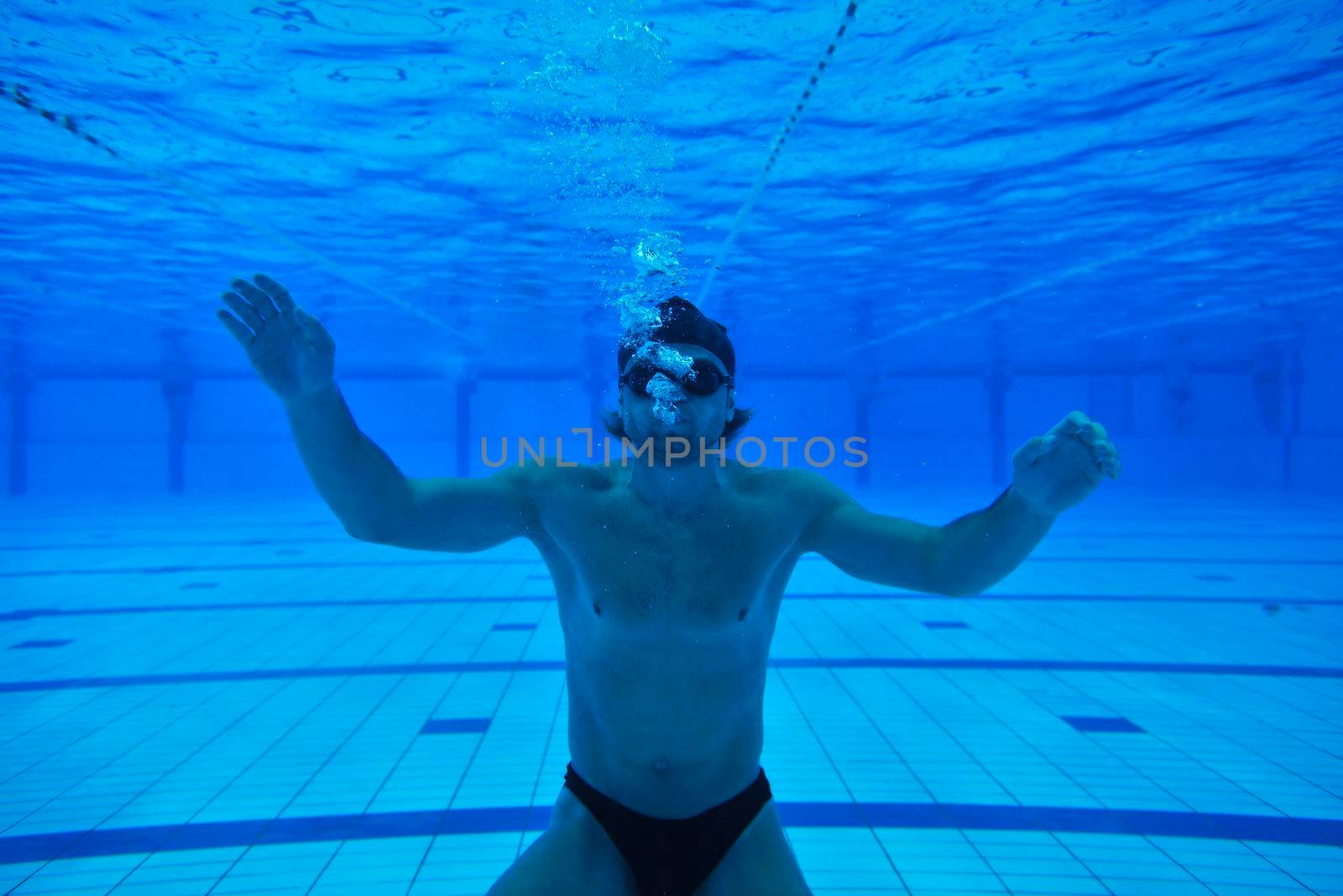 undervater shoot of swimming pool with good looking young swimmer 