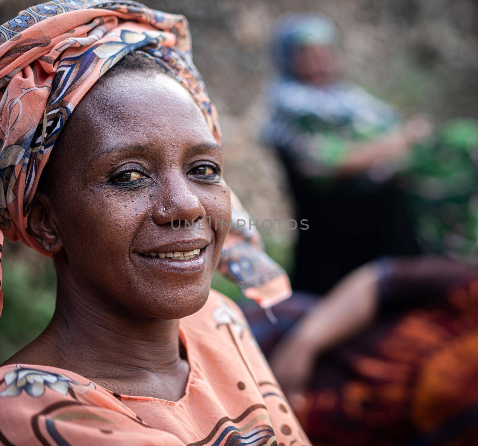 Black African senior beautiful woman with scarf outdoors