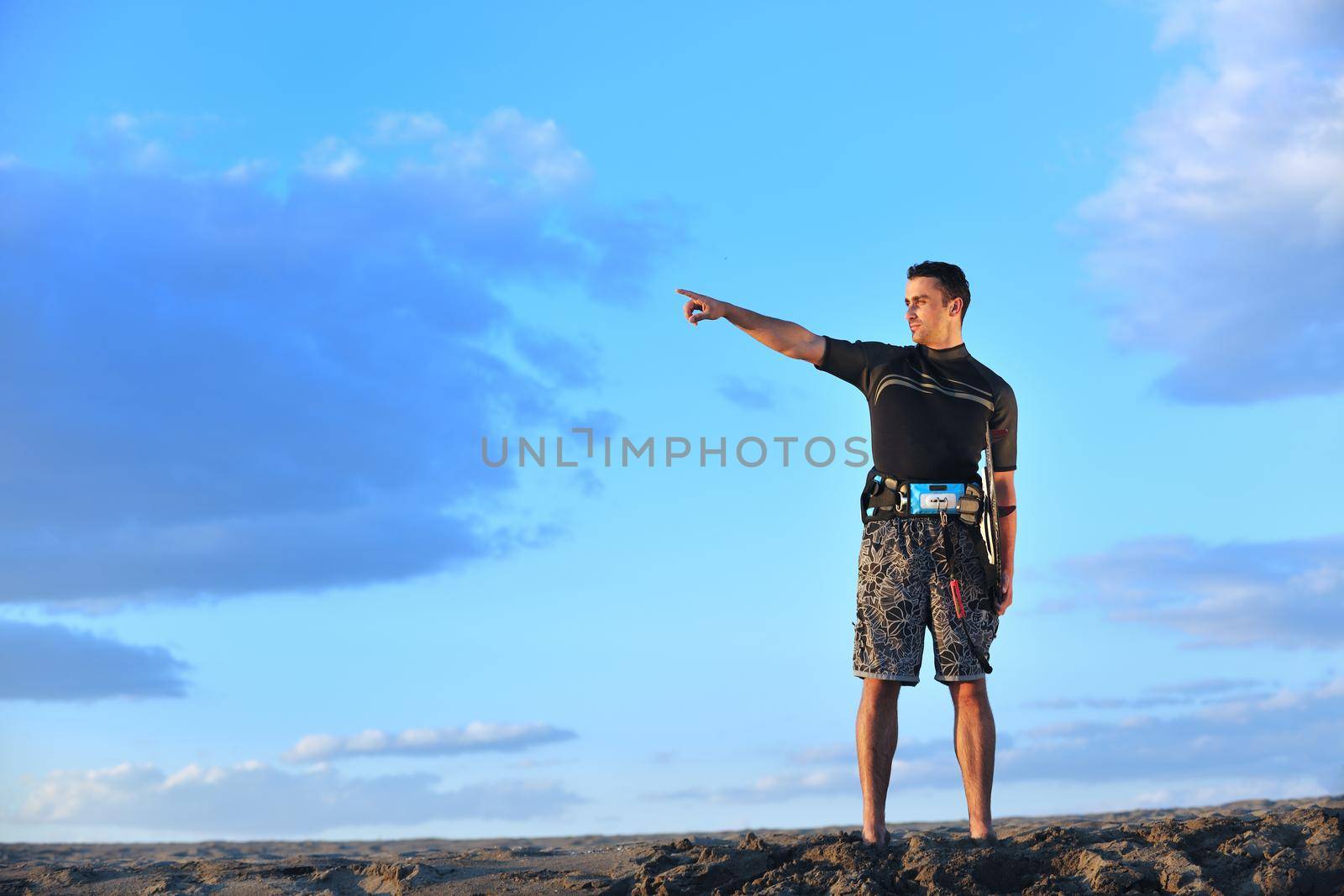 Portrait of a young  kitsurf  man at beach on sunset by dotshock