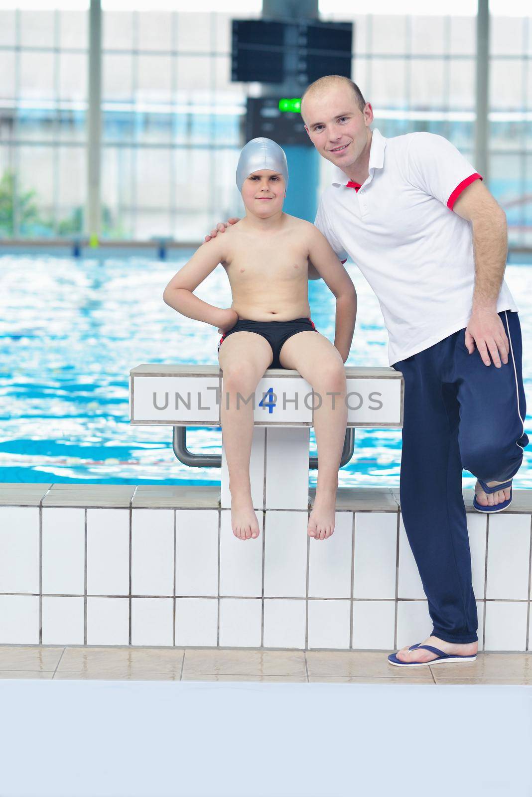 happy little child portrait on swimming school classes and recreation at indoor pool