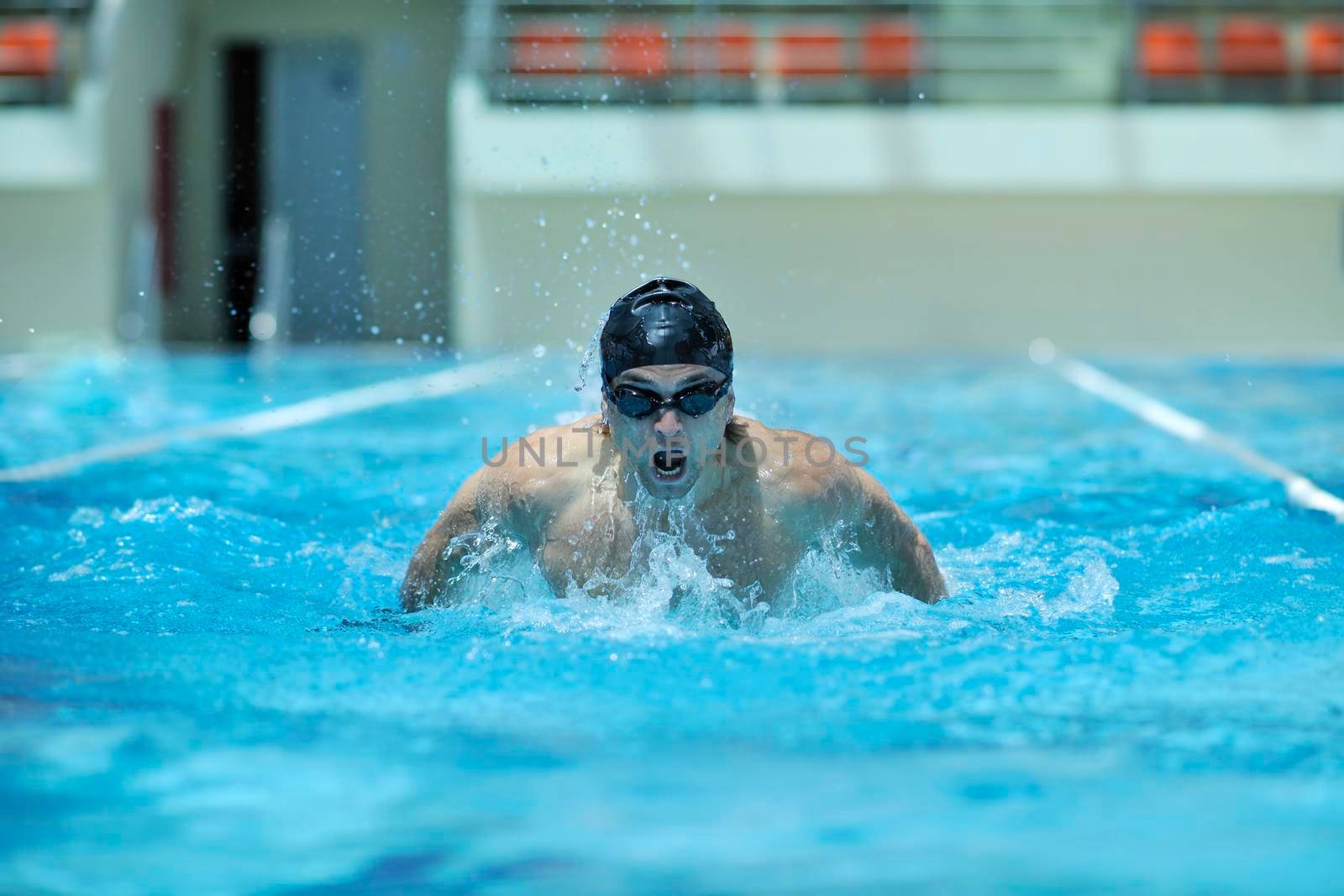 young healthy with muscular body man swim on swimming pool and representing healthy and recreation concept