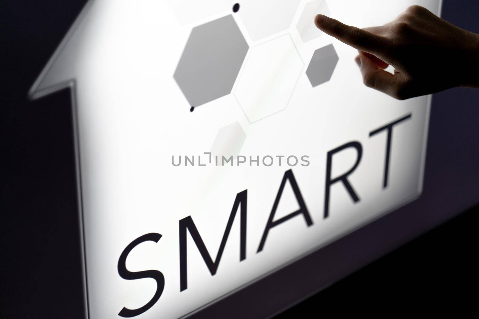 Man touching a smart home concept on a touch screen with his finger. High quality photo