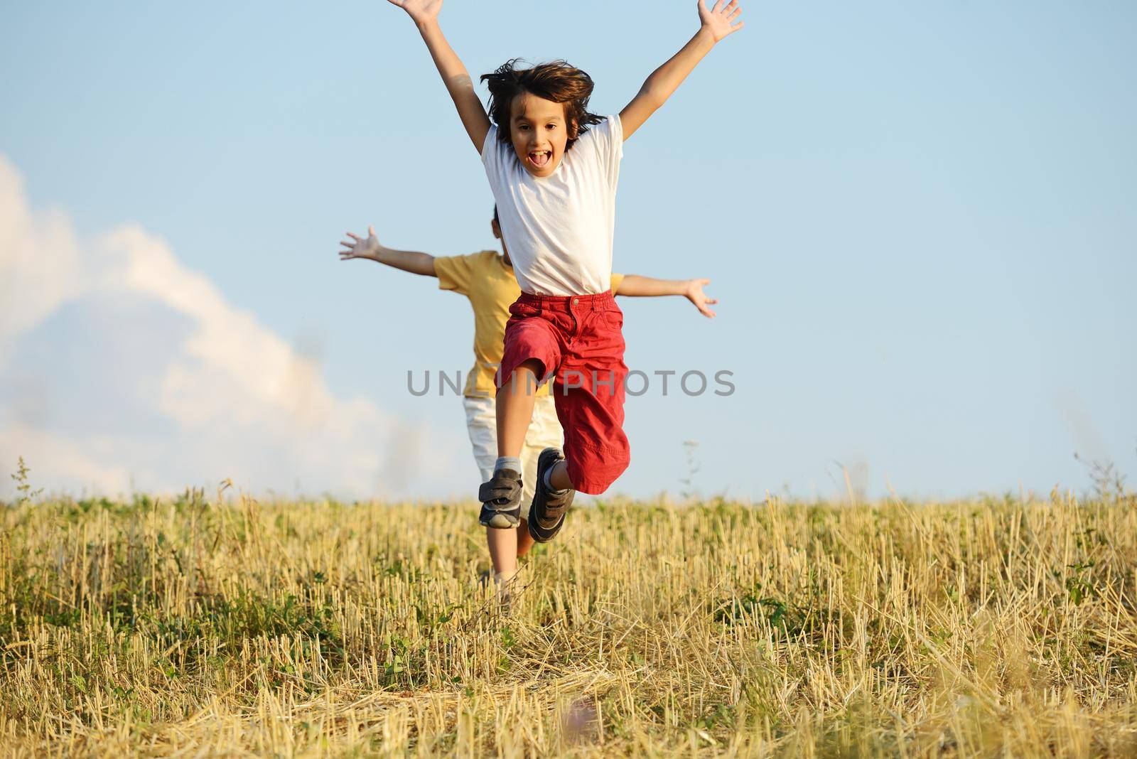 Two kids on meadow by Zurijeta