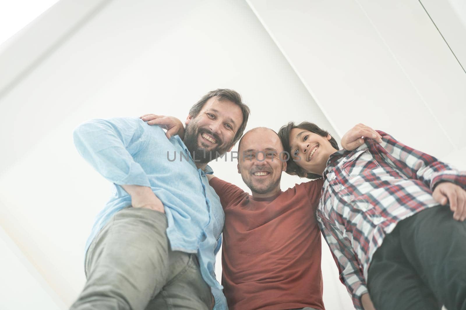 Low angle of father and sons sitting on glass