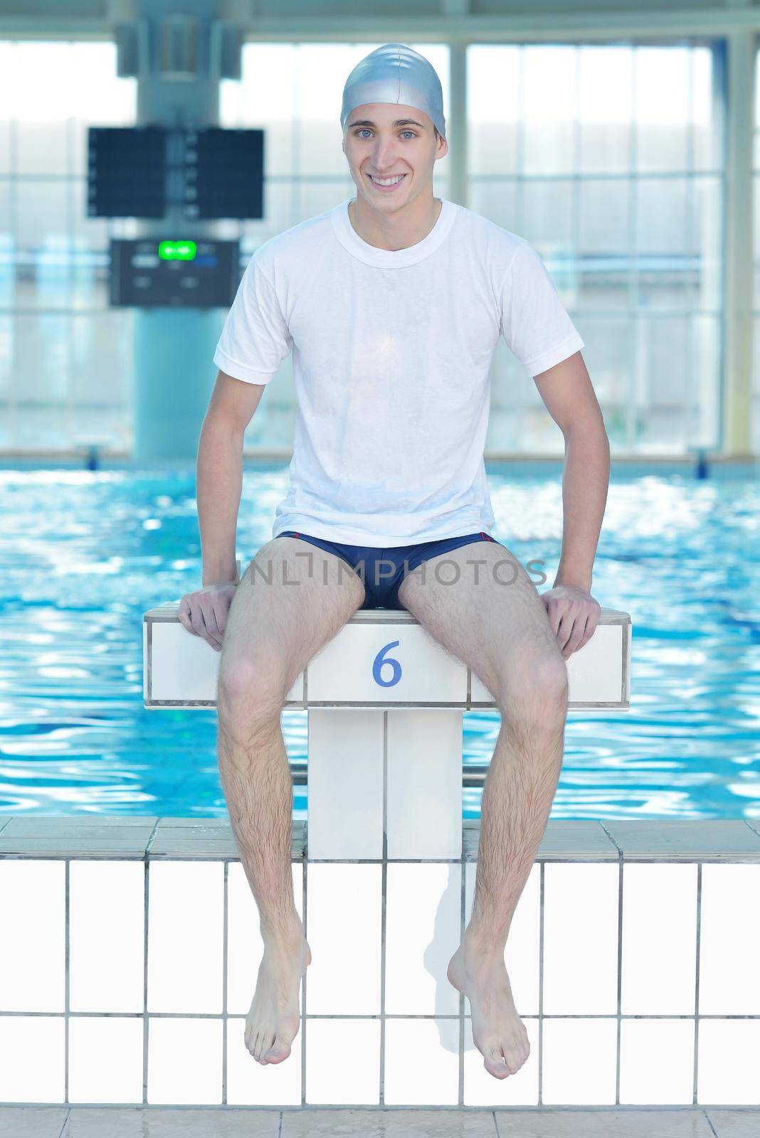 health and fitness lifestyle concept with young athlete swimmer recreating  on indoor olimpic pool