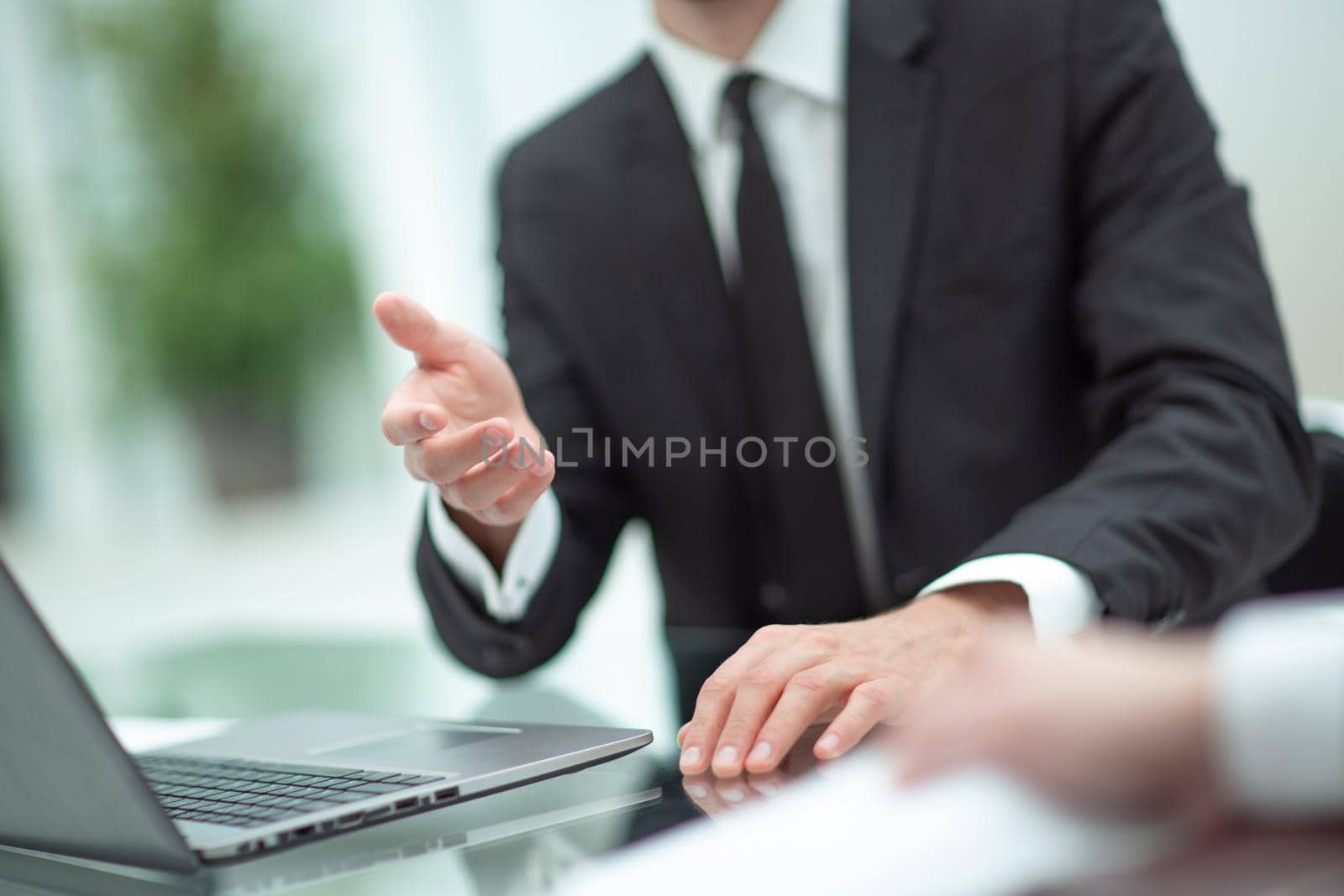 close up. businessman working on a laptop sitting at the table. by asdf