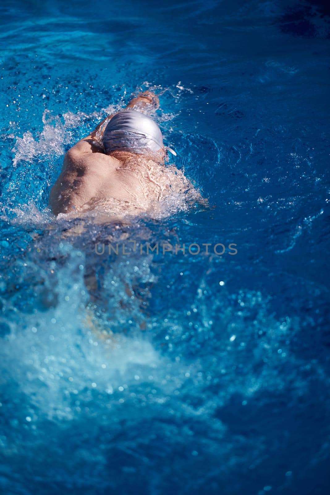 swimmer excercise on indoor swimming pool, sport and health concept