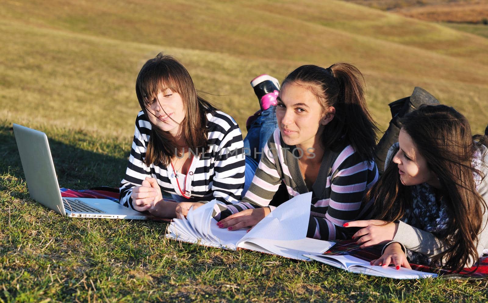 group of teen girl woman outdoor have fun and study homework on laptop computer